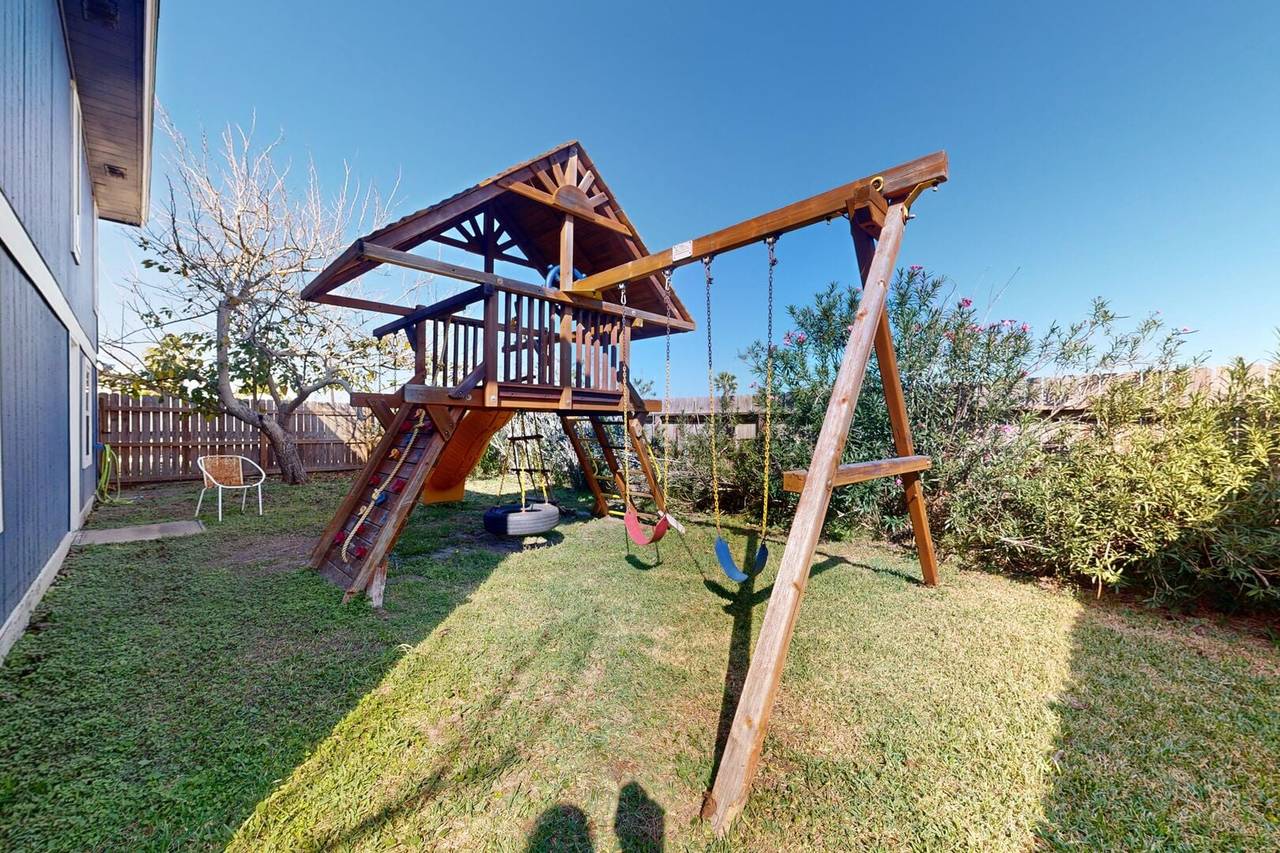 Backyard playscape with swing set and slide
